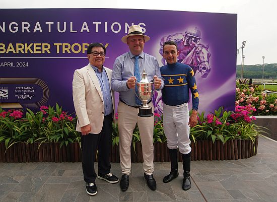 Winning trio onstage: (from left) owner Mr Lim Siah Mong, trainer Daniel Meagher and jockey Marc Lerner smiles for the camera.